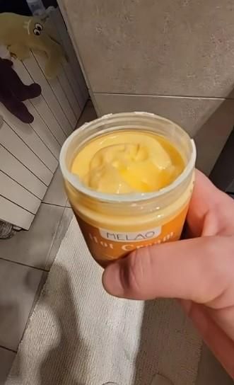 Premium body care hot cream in a jar, ideal for soothing and warming skin during self-care routines.