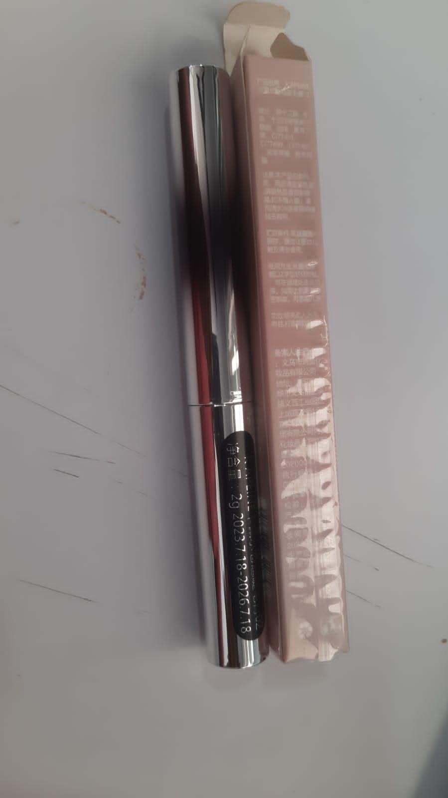 Premium iron brush mascara in sleek silver tube with packaging for enhanced volume and length