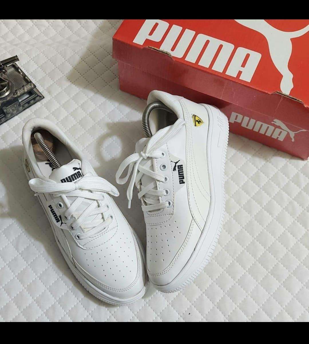 Stylish white sneakers for men by Puma, featuring a sleek design and comfortable fit, perfect for everyday wear