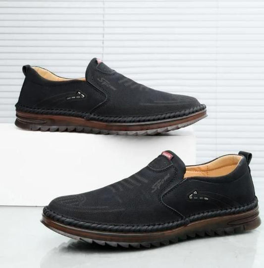 Luxury men's leather shoes in black with slip-on design and stylish stitching for elegant comfort