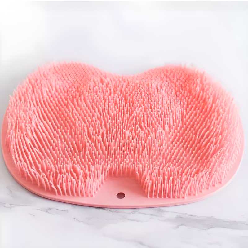 Pink silicone bath scrubber with soft bristles for gentle exfoliation in the shower