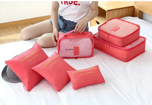 Travel packing cubes set in pink featuring various sizes for organized packing and laundry storage