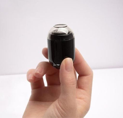 Compact electric shaving machine held in hand, perfect for travel and quick touch-ups