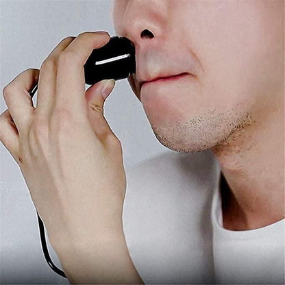 Man using electric shaving machine for facial hair grooming with precision and ease
